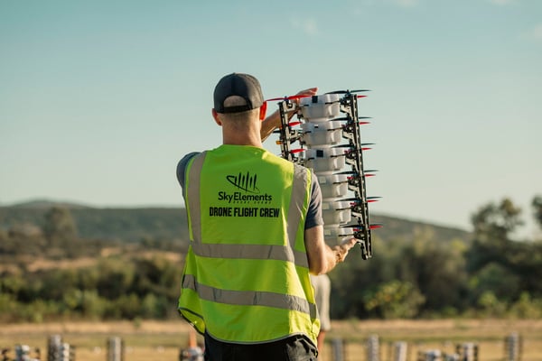 Drone-show-crew-member-walking-with-drones