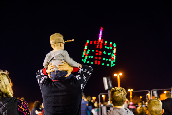 a child watching a holiday drone show