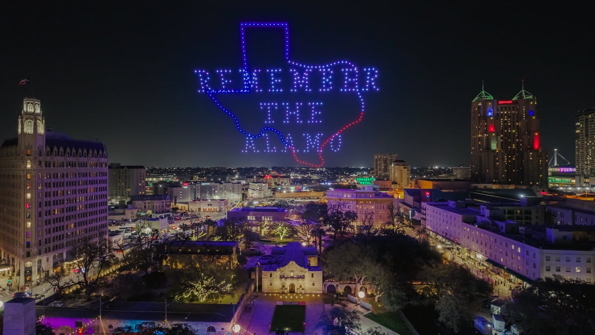 a drone show above the alamo reading