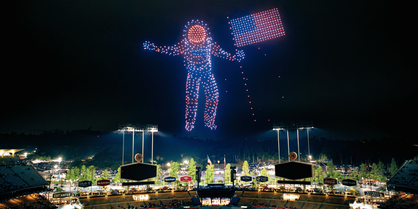 Drone lights showing an astronaut holding American flag by Sky Elements Drone Shows