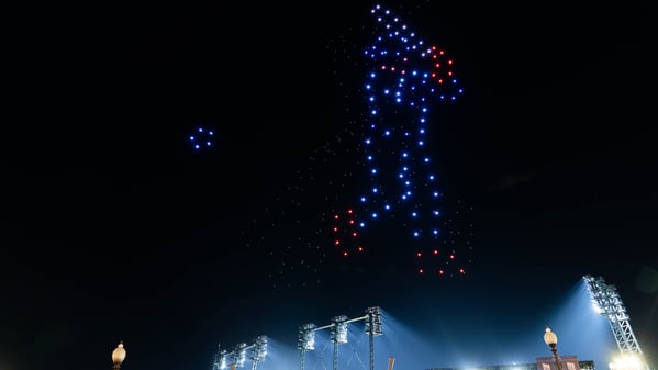 a drone show creates the image of a baseball player hitting a ball