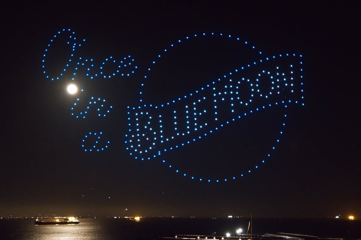 a drone show for the beer brand blue moon shows the logo next to the full moon