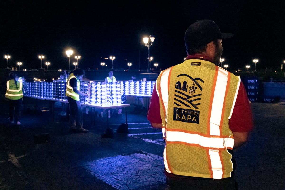 Crew members in reflective vests labeled