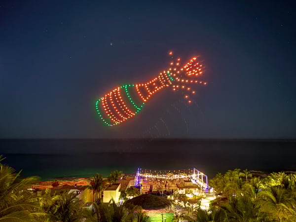 a drone show showing a bottle of champagne popping