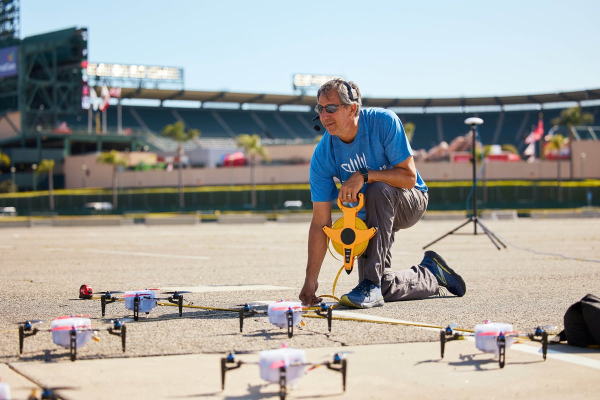 a worker aligns drones for the use of a drone show