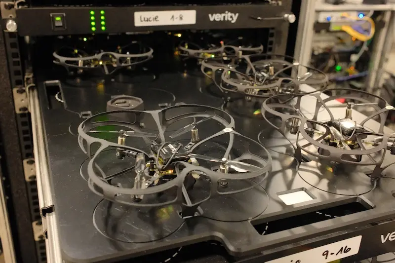 Close-up of guarded Verity indoor drones in their charging rack
