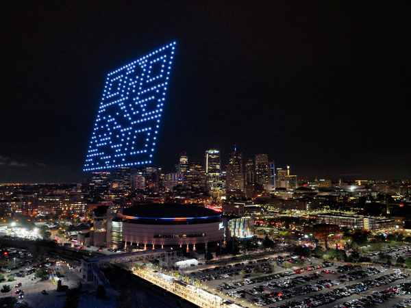 a drone show showing a QR code above Denver