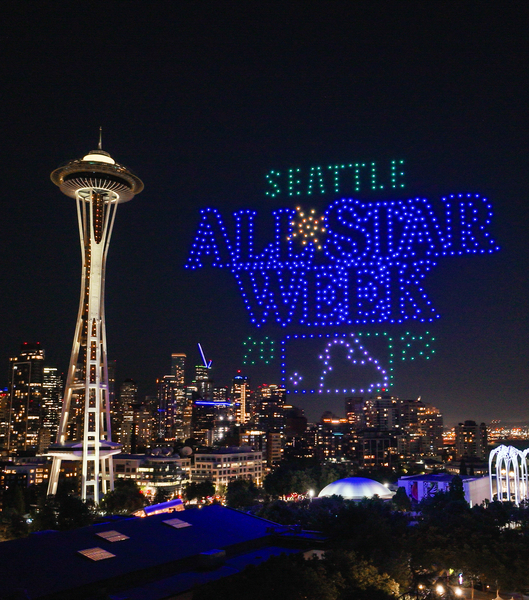 a drone show near the space needle shows the logo for the all star week in 2023