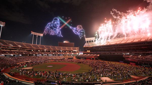 Luke Skywalker and Darth Vader having a lightsaber duel over RingCentral Coliseum